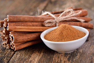 Cinnamon powder in a bowl on table wooden