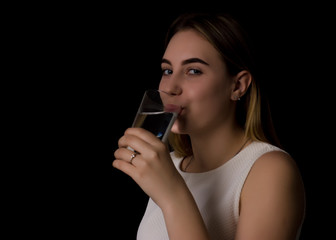 Fototapeta premium Young pretty woman drinks water Bottle or glass of spring water 