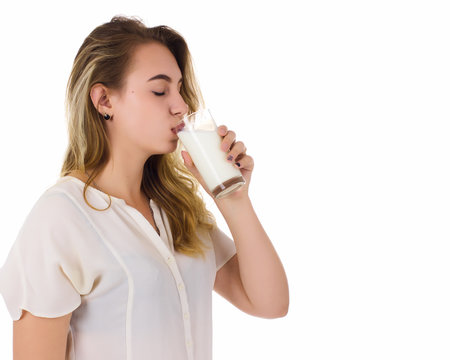 Young pretty girl, glass of milk, white background  