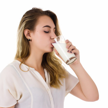 Young pretty girl, glass of milk, white background  