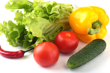 Assorted vegetables, fresh bell pepper, tomato, chilli pepper, cucumber and lettuce isolated on white background. Selective focus.
