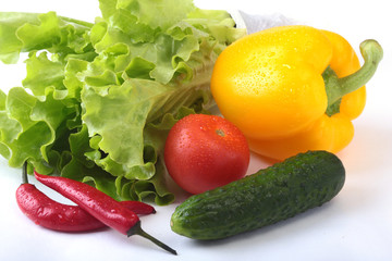 Assorted vegetables, fresh bell pepper, tomato, chilli pepper, cucumber and lettuce isolated on white background. Selective focus.