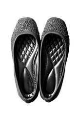Lady black leather shoes isolated on a white, top view