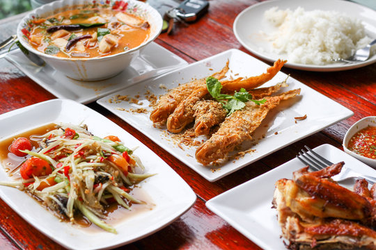Thai food, papaya spicy salad with grilled chicken and fried fish
