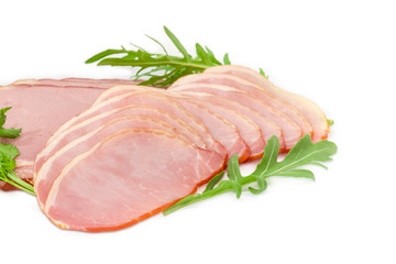 Sliced cooked pork loin and ham with greens closeup