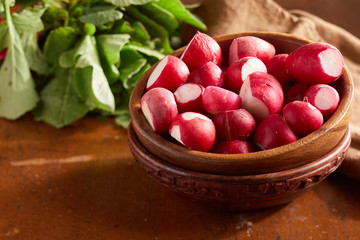 Fresh radishes in wooden bowl