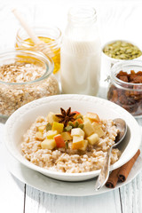 plate of oatmeal with apples, vertical