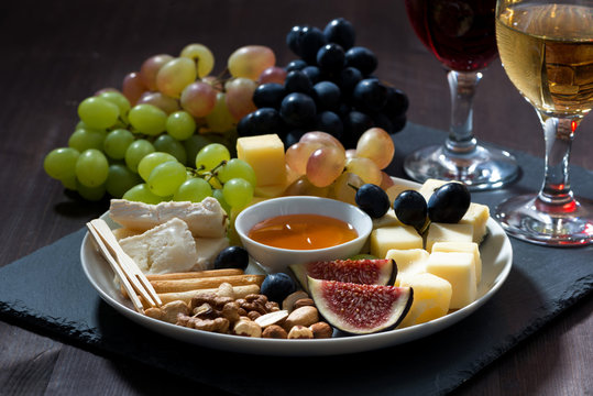 Plate with deli snacks and wine, closeup