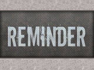 REMINDER painted on metal panel wall.
