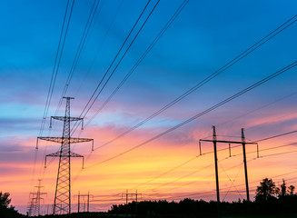 high voltage post. High-voltage tower sky background,besides the highway.