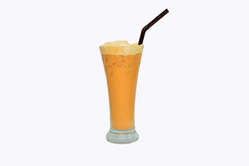 Cold milk tea in a glass with ice and a tube isolated on white background.
