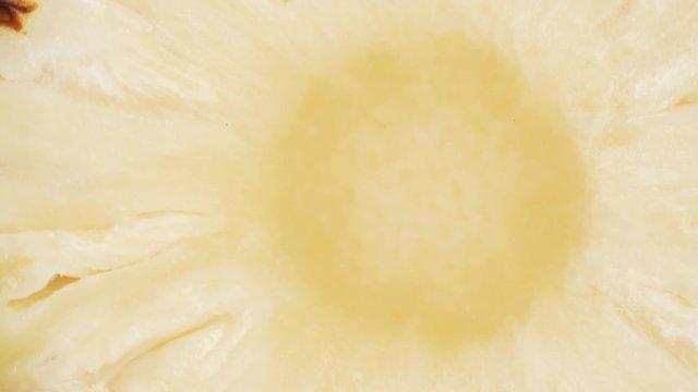 The pineapple slice rotates on the turntable