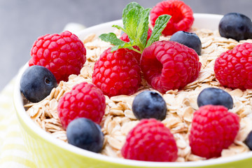 Oatmeal porridge with berries. Raspberries and blueberries.