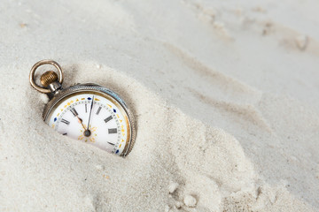 Old watch in the sand