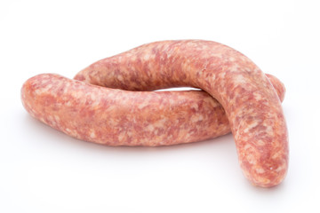 Raw sausage with parsley leaf isolated on white background.