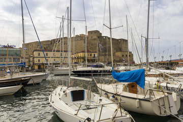 Fototapeta premium naples castel delil'ovo italy and turistic harbour