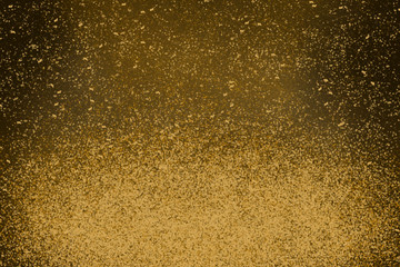 gold glitter or dust light with defocused background, star or space concept