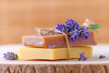 organic soap with fresh lavender flowers on wooden, closeup