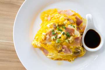Scrambled omlette eggs with pork ham on rice.