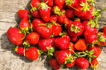 Ripe fresh strawberries on rustic wooden background. Top view