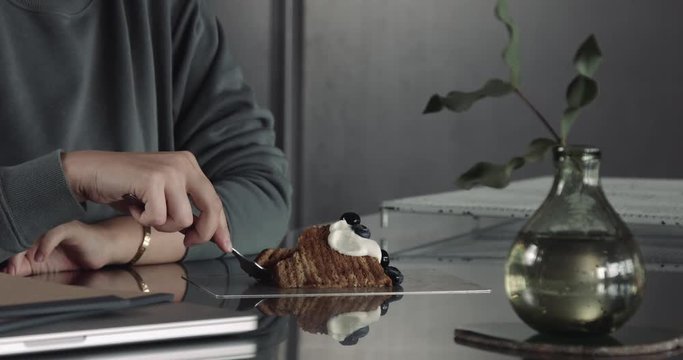 woman cut a piece of cake in one single movement and turn it to the mouth