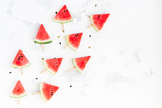 Watermelon popsicle. Sliced watermelon on white background. Flat lay, top view