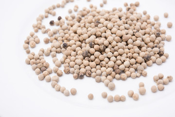 white peppers in white plate on the white background