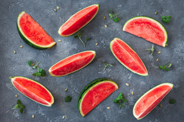 Watermelon on dark table. Sliced watermelon on black background. Flat lay, top view