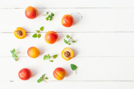 Apricot on white wooden background. Sliced apricot top view, flat lay
