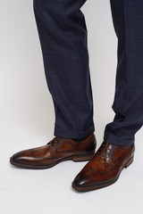 Close-up of trousers leg and fashionable men's shoes, isolated