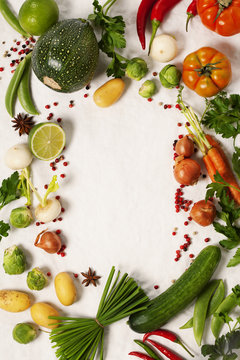 Frame of organic vegetables on white