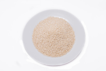 White Sesame Seeds on white plate at on white background