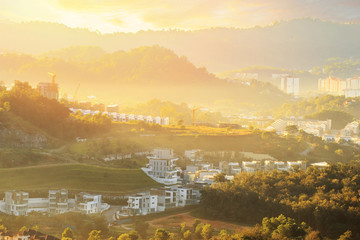 Aerial view of colourful new built houses and villa's in a residential area in Kuala Lumpur with sunset flare
