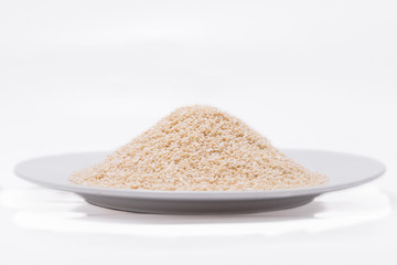 White Sesame Seeds on white plate at on white background