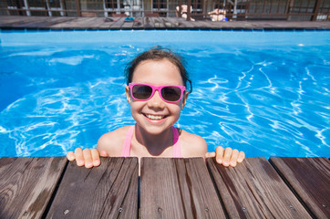 little girl  swimming  in pool