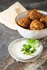 Middle Eastern traditional dishes. Falafel with sour cream. Vegetarian food.