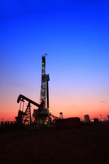 In the evening, the silhouette of oilfield derrick