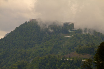 Fototapeta na wymiar Mountain slopes in a foggy cloudy summer day