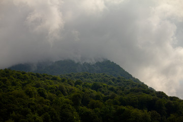 Mountain slopes in a foggy cloudy summer day