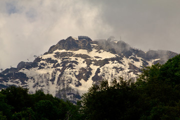 Fototapeta premium Mountain slopes in a foggy cloudy summer day