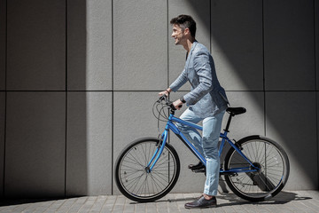 Fototapeta premium Hilarious smiling male person ready for bicycle trip