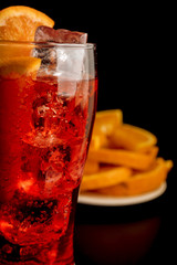 Summer cocktail aperitif with orange bitter, ice and soda