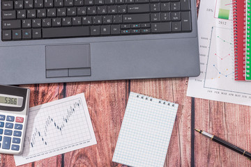 data on charts and graphs  with laptop and notepad on desk, finance  accounting.