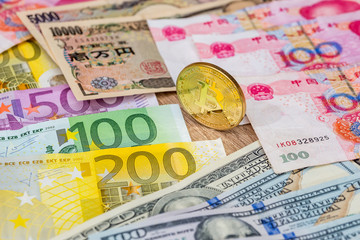 yen, yuan, euro and dollar banknotes with bitcoin