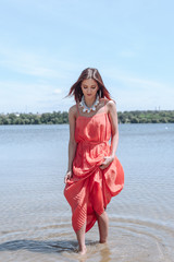 Summer fashion portrait of a beautiful young woman or girl on the beach