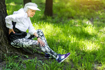 Tired old woman resting after strong training outdoors