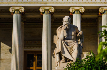 Marble statue of the Greek philosopher Socrates on the background of classical columns