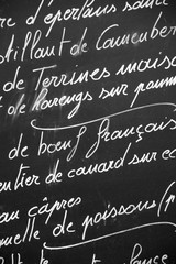 Close up of a French restaurant menu written with chalks on blackboard, Paris France - French cuisine, France travel and tourism concept