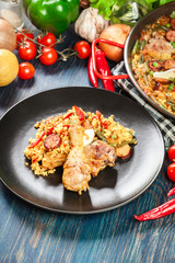 Traditional paella with chicken legs, sausage chorizo and vegeta