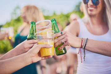 Group of friends making a toast, chatting and smiling st the party